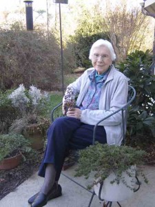 Photo by Ken Moore. Evelyn Sims holding a native oregano for her garden.