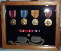 Display case of replcement medals, with Bill Hurley's original dog tags.