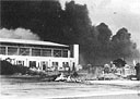 smoke pours from burning aircraft and buildings at Hickam Field following the Japanese attack