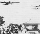 B-17 aircraft flying over the main gate at Hickam Field, circa 1941