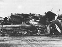 looking through a heap of wrecked planes at Wheeler Field for salvageable parts