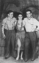 Military men pose for a souvenir photo with a hula girl at the Black Cat Cafe