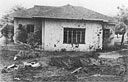 bomb crater in the front yard 
of family quarters at 540 Wright Avenue