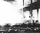 sunlight streams through the splintered mess hall roof where bombs entered