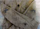 Close-up of summer coat from the group showing both P.F.C. insigne and Expert Rifleman's mark in green on khaki