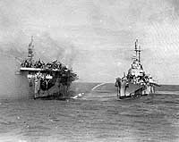 Photo # 80-G-281660-2:  USS Birmingham comes alongside the burning USS Princeton to assist with fire fighting, 24 October 1944