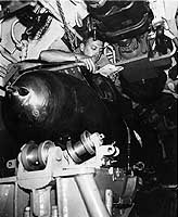 Photo # 80-G-49448:  Crewman on USS Bullhead reading in his bunk atop a torpedo rack, 1945.  Photographed by Stephen F. Birch.