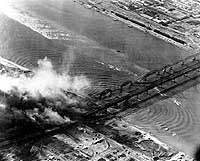 Photo # 80-G-423495: Planes from USS Leyte attack bridges over the Yalu River at Sinuiju, North Korea, Nov. 1950