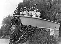 Photo # NH 67888:  Navy personnel pose with USS Tennessee's bow decoration, erected as a monument at Nashville, Tennessee.
