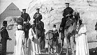 Photo # NH 101495:  Great White Fleet Sailors pose atop camels at the base of the Sphinx, January 1909