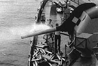 Photo # NH 103718:  Crewmembers cooling USS Beale's forward five-inch gun, possibly after a gunfire support mission off Vietnam in 1966