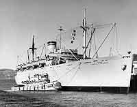 Photo # NH 103783:  USNS David C. Shanks alongside a pier during the 1950s.
