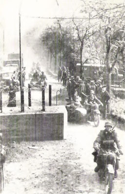 German motorized divisions passing through the barricades of a Luxembourg frontier road on May 10, 1940