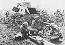 An armoured car crew cleaning their Vickers machine-guns.