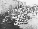 After being brought in from the surrounding hills, captured Italian field and heavy guns are lined up beside the fort at Mega.