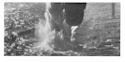 The U-boat is engulfed in the plumes from the explosions.