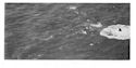 The plumes subside, leaving 30 feet of the U-boat's bow protruding vertically from the water.
