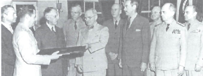 Colonel Bernard Thielen, presenting President Truman  and others with the Japanese surrender document