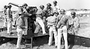 MEN CLEANING A 3-INCH ANTIAIRCRAFT GUN M3 (top); members of a machine
gun crew operating a Browning machine gun HB .50-caliber, flexible (bottom).