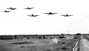 MEDIUM BOMBERS, B-18'S (top) and pursuit planes, P-36's (bottom) of the
U.S. Far East Army Air Force attack infantry troops during 1941 maneuvers in
the Philippines. When the Japanese attacked the Philippine Islands the United
States had some 300 aircraft in the Far East Air Force, but of these only 125
were suitable for combat. The 300 planes represented over 10 percent of the total
U.S. air strength at this time. The pilots and crews were well trained and lacked
only combat experience.