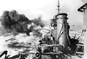 PT (MOTOR TORPEDO) BOAT NEAR MARCUS ISLAND, which was attacked
4 March 1942 (top); U.S. cruiser firing at Wake, 24 February 1942 (bottom). The
aircraft carrier Enterprise, two cruisers, and seven destroyers comprised the task
force attacking the island of Wake. The Enterprise and two cruisers were the
main ships used during the Marcus Island attack, 1,200 miles from Japan.
Losses to the U.S. forces during these attacks were light and the effectiveness of
the use of fast, powerful, carrier task forces was demonstrated.