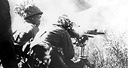 JAPANESE SOLDIERS FIRING A MACHINE GUN TYPE 92 (1932) 7.7-mm.
heavy machine gun, gas-operated and air-cooled. This was the standard Japanese
heavy machine gun (top). Japanese firing a 75-mm. gun Type 41 (1908), 
normally found in an infantry regimental cannon company (bottom). Called a
mountain (infantry) gun, it was replaced by a later model. Light and easily
handled, it was very steady in action. When used as a regimental cannon company
weapon it was issued on the basis of four per regiment.