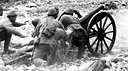 JAPANESE SOLDIERS FIRING A MACHINE GUN TYPE 92 (1932) 7.7-mm.
heavy machine gun, gas-operated and air-cooled. This was the standard Japanese
heavy machine gun (top). Japanese firing a 75-mm. gun Type 41 (1908), 
normally found in an infantry regimental cannon company (bottom). Called a
mountain (infantry) gun, it was replaced by a later model. Light and easily
handled, it was very steady in action. When used as a regimental cannon company
weapon it was issued on the basis of four per regiment.