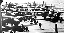 B-25'S ON THE FLIGHT DECK of the aircraft carrier USS Hornet before taking 
off to bomb Tokyo on 18 April 1942 (top); B-25 taking off from the flight
deck of the Hornet (bottom). In a small combined operation in the western
Pacific by the U.S. Navy and the Army Air Forces, sixteen planes took off from
the carrier Hornet, 668 nautical miles from Tokyo, to bomb the city for the first
time during the war. The Japanese were completely surprised because, even
though they had received a radio warning, they were expecting Navy planes
which would have to be launched from a carrier closer to Tokyo, and therefore
would not reach the city on 18 April.