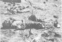 AN AMERICAN MARINE, IN FOREGROUND, STILL CLUTCHES THE KNIFE WITH WHICH HE KILLED THE JAP, IN BACKGROUND