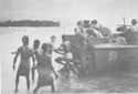 COAST GUARD LANDING CRAFT MET BY GROUP OF POLYNESIAN NATIVES AT EMIRAU ISLAND
