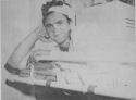 COAST GUARDSMAN CHARLES SHERIS HAS A BIG GRIN DESPITE SHRAPNEL WOUNDS RECEIVED WHEN GERMAN BOMBERS ATTACKED A COAST GUARD-MANNED TRANSPORT CARRYING SOLDIERS FOR THE INVASION OF GELA, SICILY
