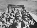 U.S. COAST GUARDSMEN TAKE A PARTY OF NAVY MEN ASHORE TO SET UP A NAVAL OPERATING BASE ON THE SICILIAN SHORE