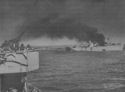 AN AMERICAN CARGO SHIP HIT BY NAZI DIVE BOMBERS IN AN AIR RAID ON A CONVOY IN THE INVASION OF SICILY