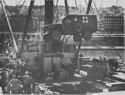 U.S. COASTGUARDSMEN LOAD AN AMBULANCE ABOARD THEIR TRANSPORT AT A NORTH AFRICAN PORT AS THEY PREPARE TO SAIL FOR SICILY