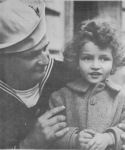 COAST GUARDSMAN STEPHEN G. FERKO POSES WITH A NEW CHUM
