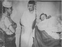 A COAST GUARDSMAN GUARDS TWO SLIGHTLY WOUNDED NAZI PRISONERS ABOARD A U.S. COAST GUARD-MANNED COMBAT TRANSPORT OFF SALERNO, ITALY