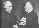 ADMIRAL R.R. WAESCHE, COMMANDANT OF THE U.S. COAST GUARD, IS SHOWN AT THE LEFT PINNING THE SILVER STAR ON COMMANDER JAMES S. HUNT