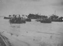 AT PAESTUM, SOUTH OF SALERNO, BULLDOZERS, AMPHIBIOUS DUCK TRUCKS, AND OTHER HEAVY EQUIPMENT BEING UNLOADED