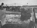 A COAST GUARD MANNED LCM UNLOADS ITS CARGO AT THE BEACH, SALERNO