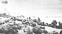 Assault force under enemy fire at O<font size=-1>RANGE</font> Beach 3. Note burning amtracs in background