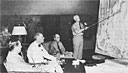 ADMIRAL NIMITZ briefs General MacArthur, President Roosevelt, and Admiral Leahy at the
 July 1944 Pearl Harbor conference.
