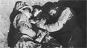 Two Marines of the 6th Division safeguard a young Okinawan until he can be reunited with his family.