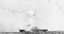 USS Enterprise is hit on 14 May 1945 by a Kamikaze which dove out of low cloud cover.