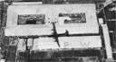 Shadow of a B-29 on a supply-drop mission passes over the POW camp at Nagasaki