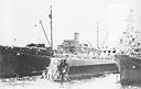 AR Repair Ship (USS Vestal AR-4 alongside damaged battleship