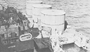 Gasoline lighter and an LCT alongside the carrier Intrepid