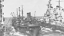 The oiler Cahaba fueling the battleship Iowa and the carrier Shangri-La on a smooth day.