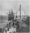Tests of Spencer Miller's coaling-at-sea rig were conducted in 1913 between the collier Cyclops and the battleship South Carolina. The battleship was equipped with a sliding padeye attached to a vertical spar mounted on South Carolina's fore deck that was used to raise and lower the highline along with the load. (U.S. Navy)