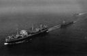Although the broadside method was the primary means for fueling at sea, diesel oil was normally dispensed from the fueling station aft using the astern method. Mattole (AO-17) uses this method on 17 August 1944 to refuel the diesel-powered escort destroyer Pride (DE-323). (National Archives) 