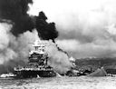 Image: 80-G-32706 Maryland and capsized Oklahoma with West Virginia's masts visible in the background.